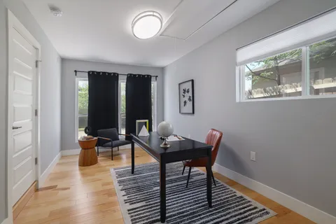 a living room with furniture and wooden floor