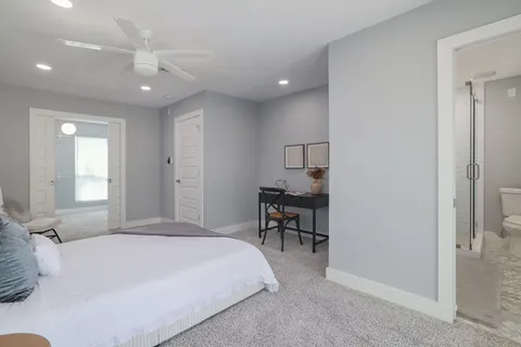 a spacious bedroom with a bed and a table in it