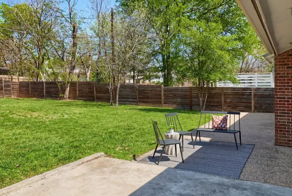 a view of backyard with seating area and green space