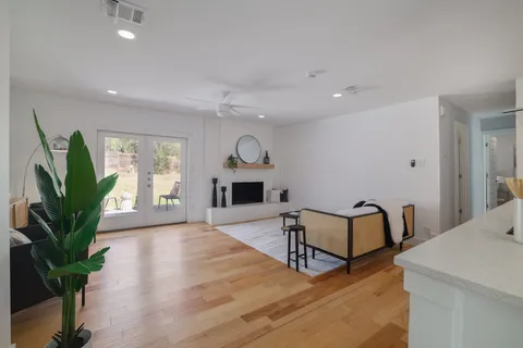 a living room with furniture a potted plant and a fireplace