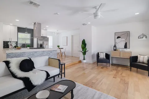 a living room with furniture and wooden floor