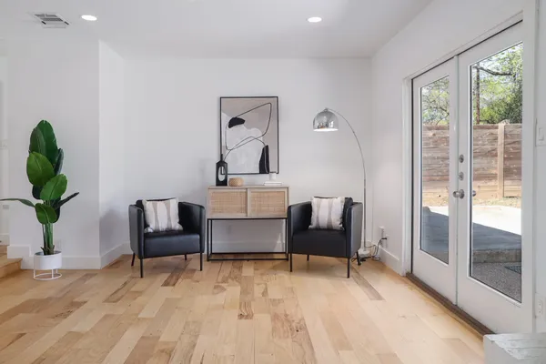 a living room with furniture and a potted plant