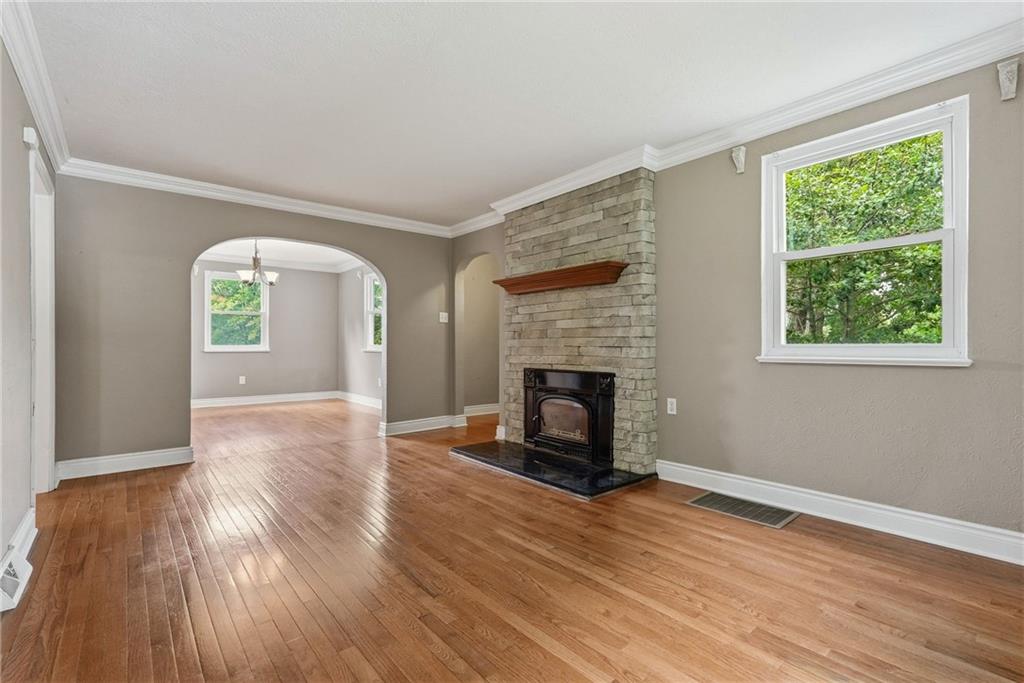 809 Franklin Road Mars, PA 16046 - Photo 10 of 44 Family room with arched doorway to dining room and continuous hardwood flooring throughout