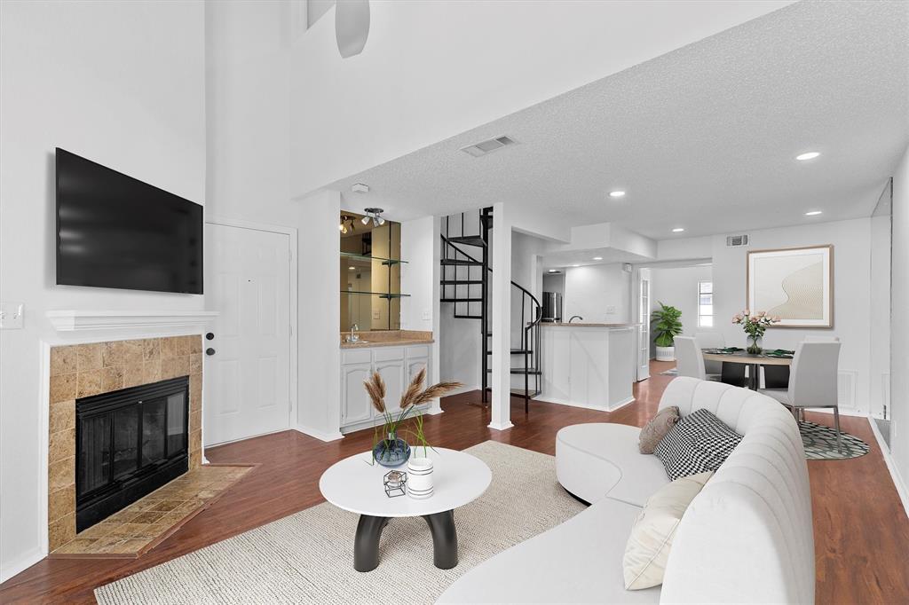 a living room with furniture a fireplace and a flat screen tv