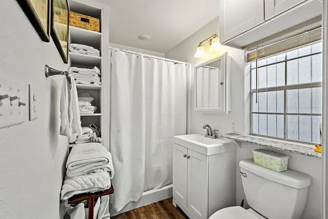 a bathroom with a sink toilet and shower