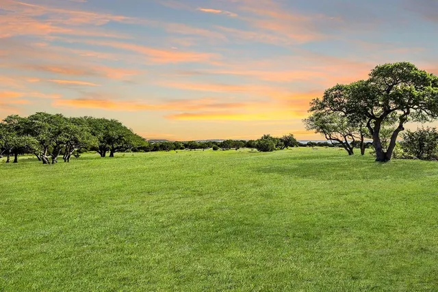 a view of a green field with clear sky