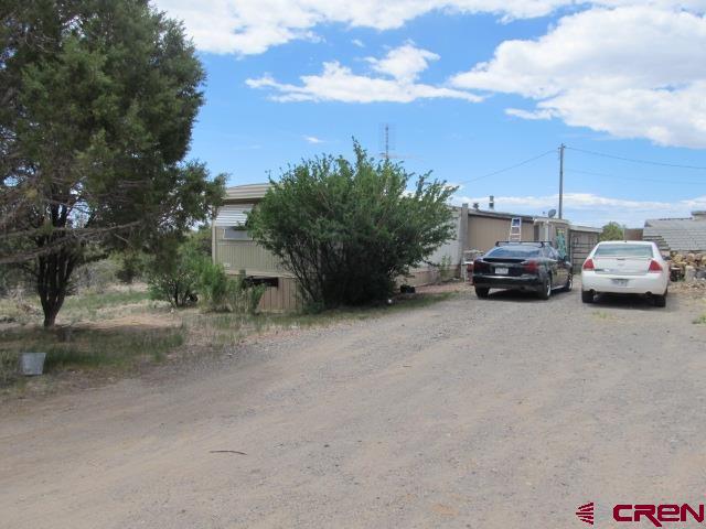 25333 Cedar Mesa Road Cedaredge, CO 81413 - Photo 1 of 19 a car parked on the side of the road