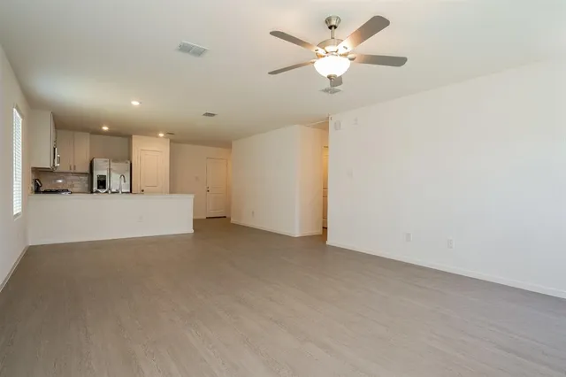 a view of a kitchen with a sink and a chandelier fan
