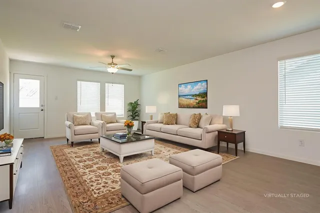 a living room with furniture and a large window