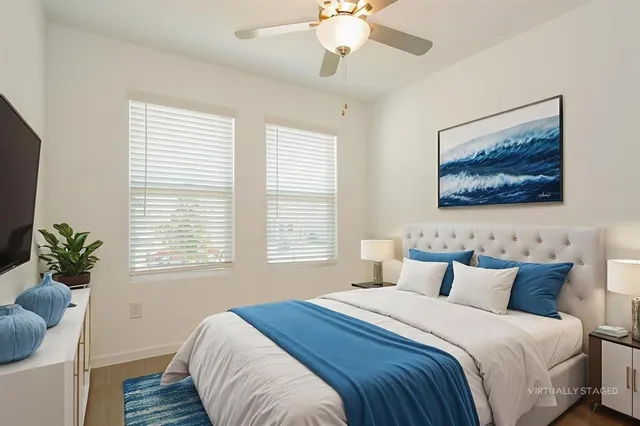 a bedroom with a bed and a painting on the wall