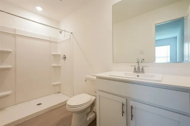 a bathroom with a sink toilet and shower