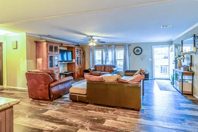 a living room with furniture and a wooden floor