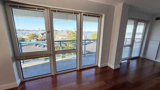 a spacious bedroom with a large bed and a large window