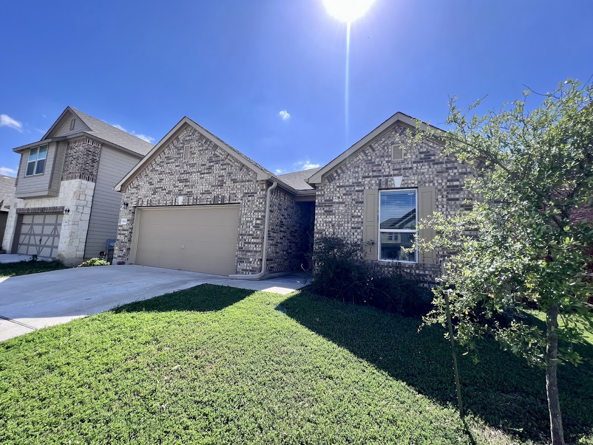7900 Crystalbrook West Austin, TX 78724 - Photo 2 of 27 a front view of a house with a yard and garage