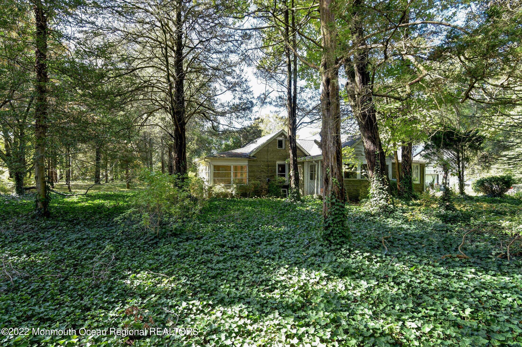 844 Monmouth Road Cream Ridge, NJ 08514 - Photo 1 of 11 a front view of a house with a yard