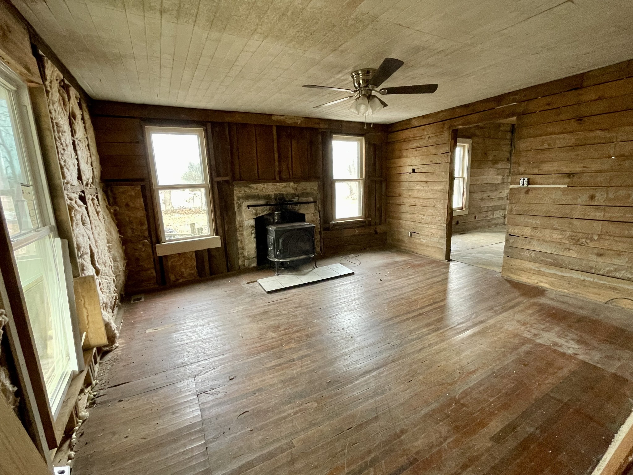 136 Scott Orchard Road Taft, TN 38488 - Photo 12 of 29 wooden floor in an empty room with a fireplace