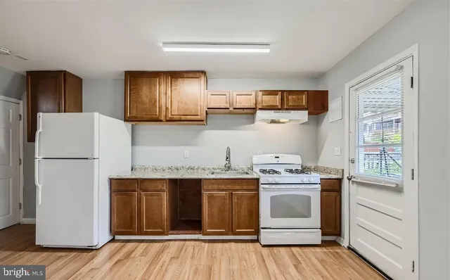 a kitchen with a stove and white cabinets