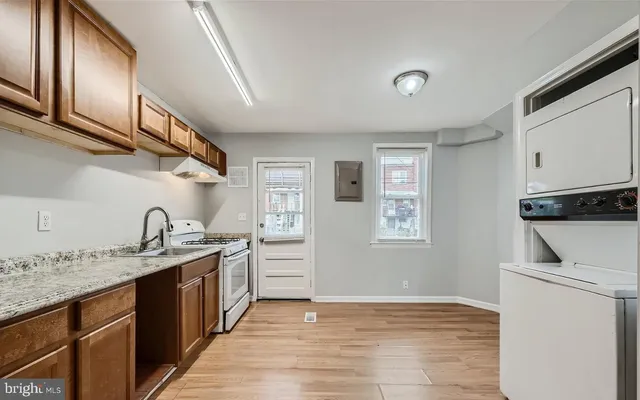 a kitchen with a sink stove and cabinets