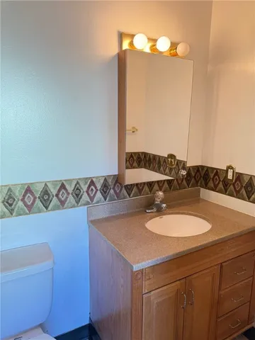 a view of a chandelier fan and entryway