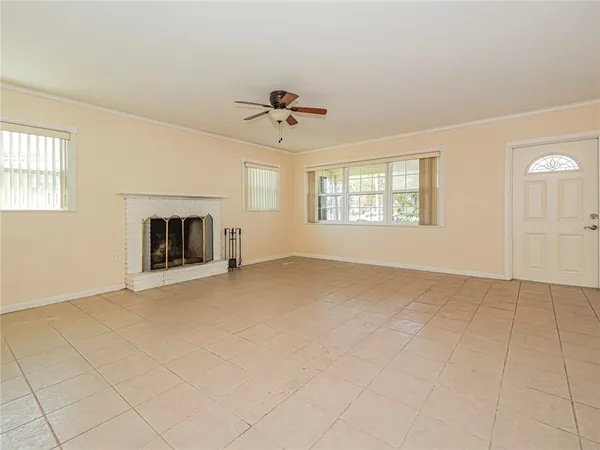 a view of empty room with fireplace and windows