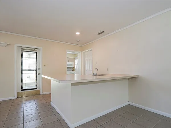 a view of empty room with window and fan