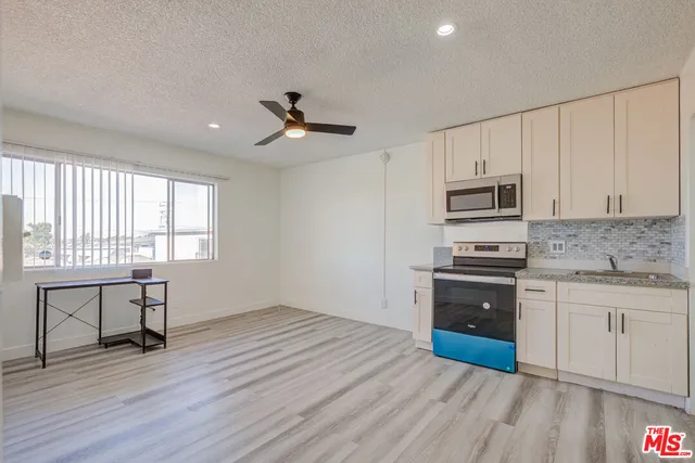 a kitchen with a stove a sink and a microwave
