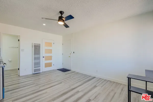 a view of empty room with wooden floor