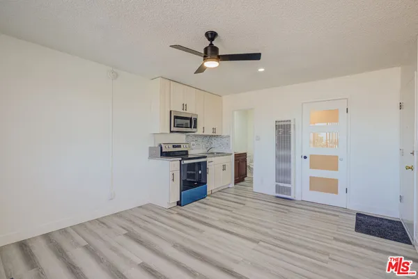 a view of kitchen with sink microwave and stove
