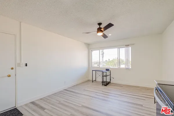 a view of a room with wooden floor and windows