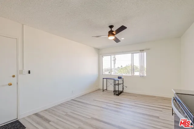 a view of a room with wooden floor and windows