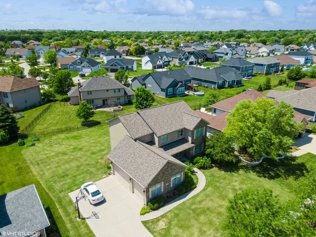 a view of a lake with a table and chairs in front of house