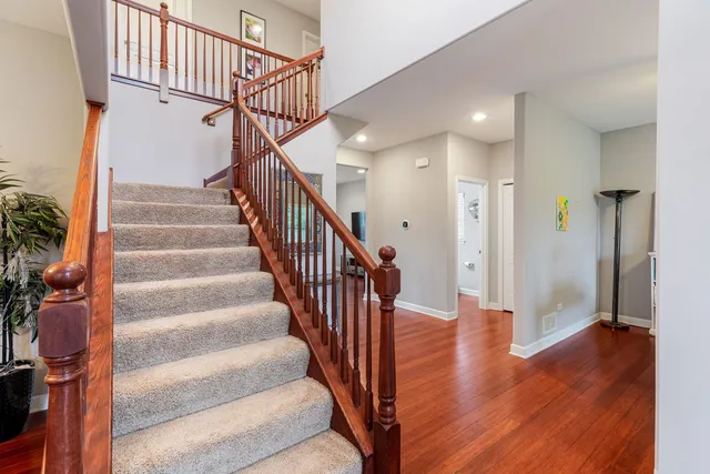 a view of entryway with wooden floor and stairs