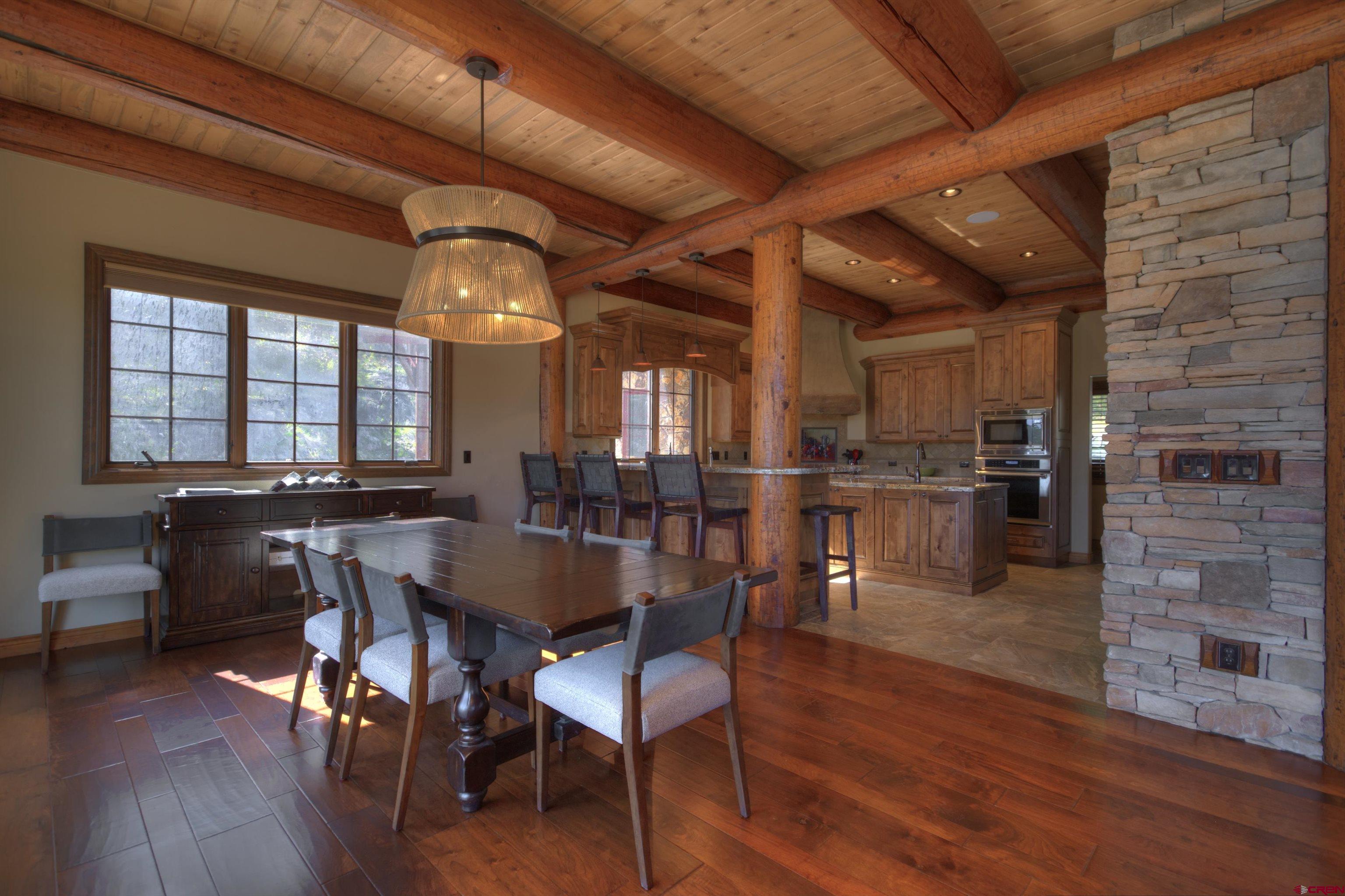 702 Jenni Lane, Unit SADDLEHORN RANCH Chromo, CO 81128 - Photo 12 of 45 a view of a dining room with furniture and wooden floor