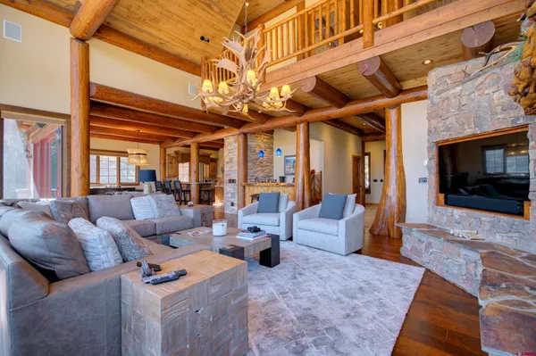a living room with furniture a flat screen tv and a fireplace