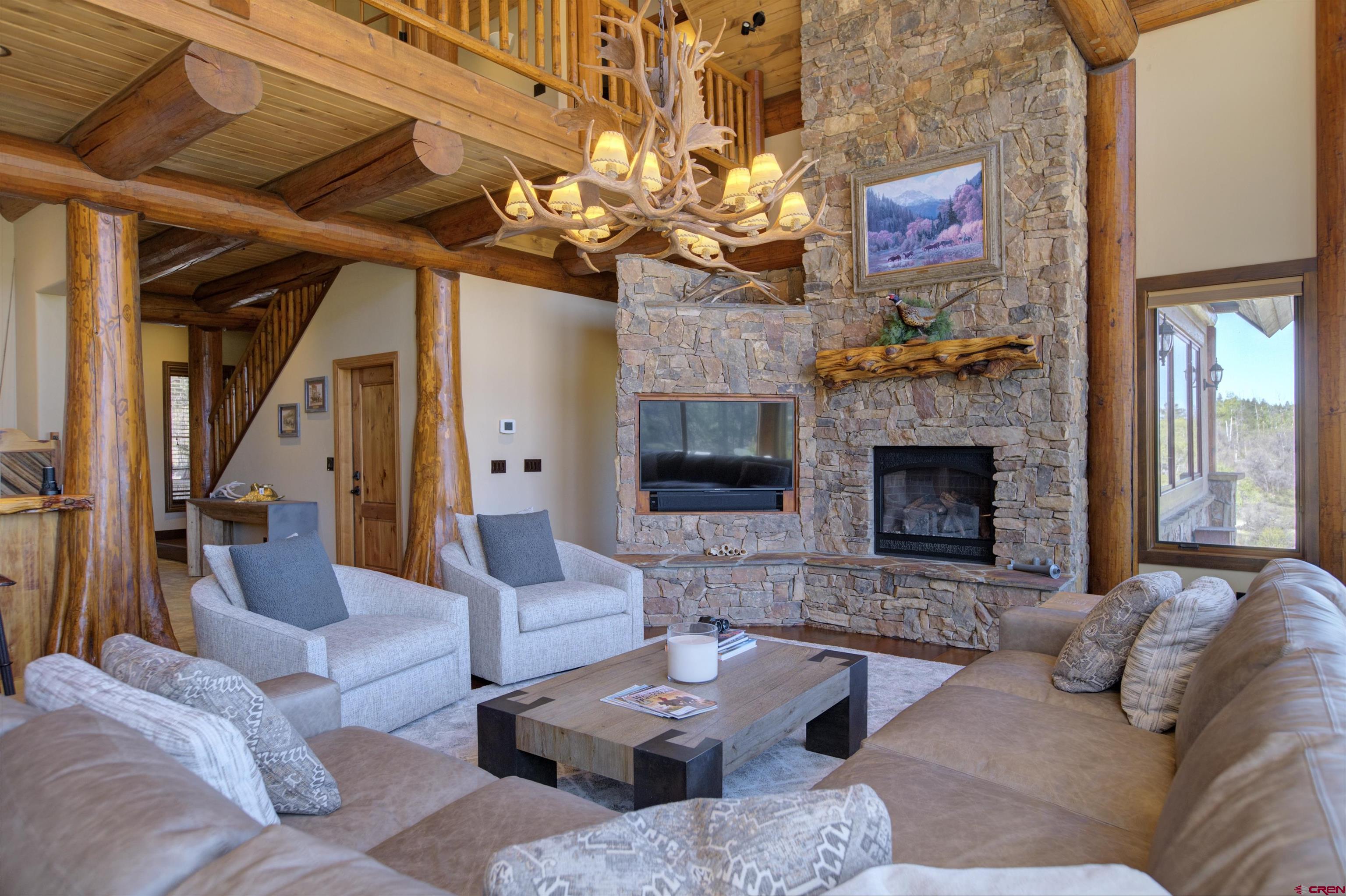 702 Jenni Lane, Unit SADDLEHORN RANCH Chromo, CO 81128 - Photo 17 of 45 a living room with furniture and a fireplace