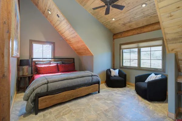 a bedroom with bed and a large window