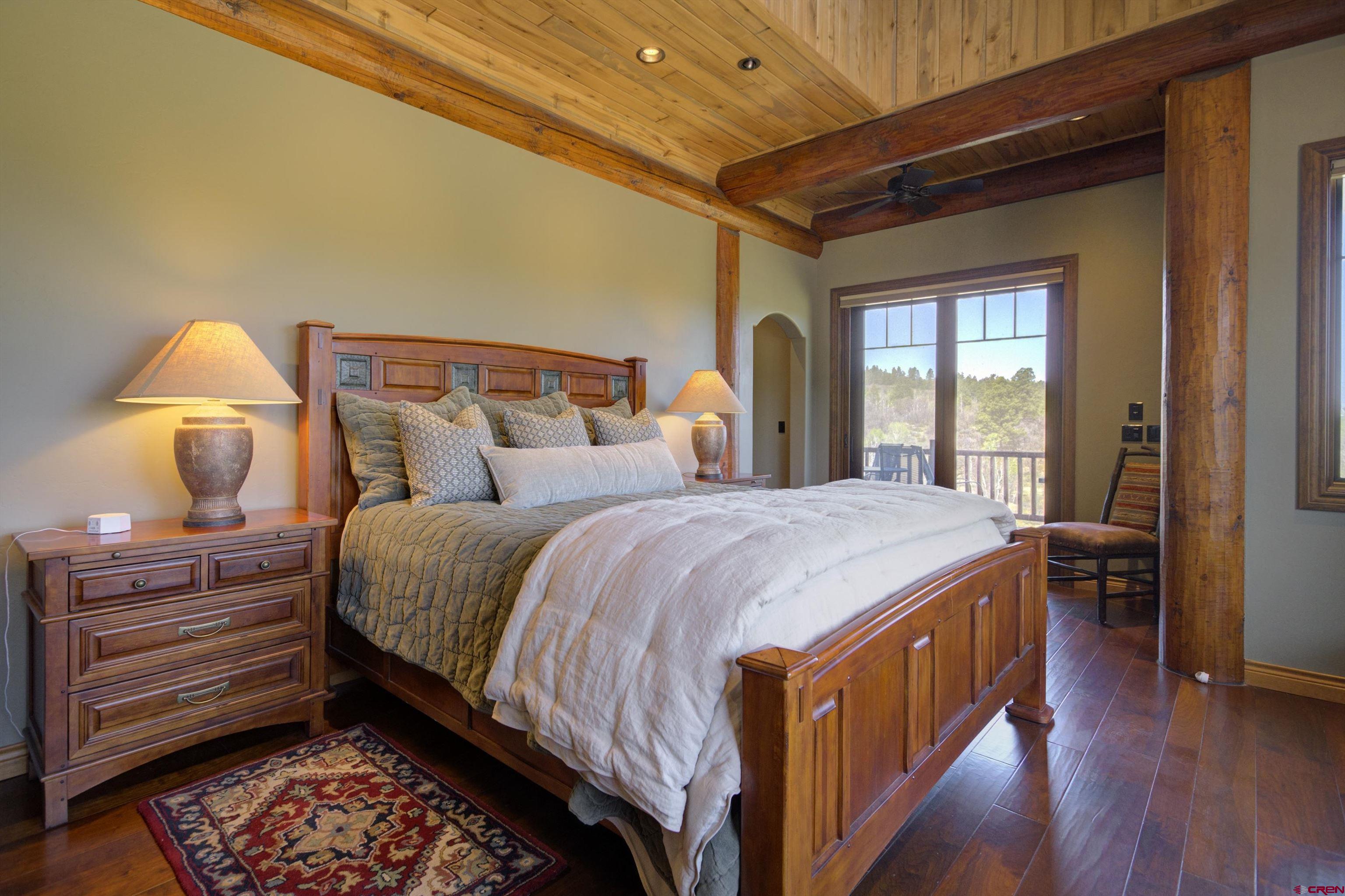702 Jenni Lane, Unit SADDLEHORN RANCH Chromo, CO 81128 - Photo 25 of 45 a spacious bedroom with a bed and wooden floor