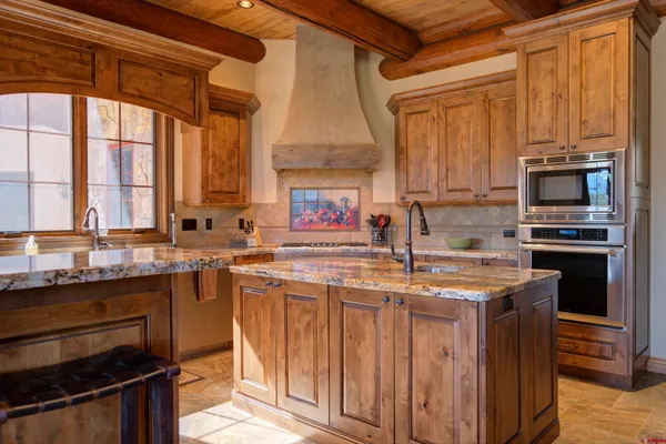 a kitchen with stainless steel appliances a stove a sink and a microwave
