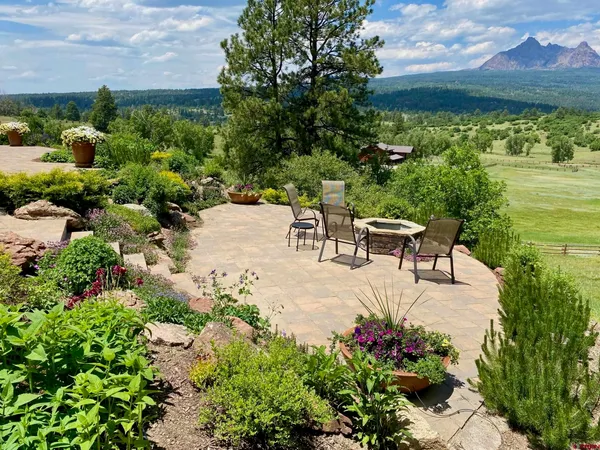 a view of a garden with an outdoor seating
