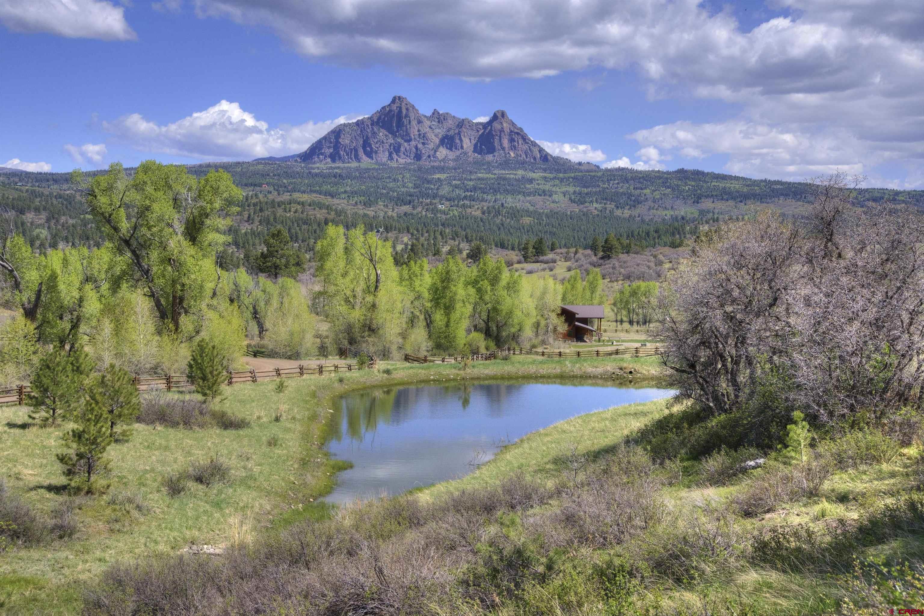 702 Jenni Lane, Unit SADDLEHORN RANCH Chromo, CO 81128 - Photo 10 of 45 a view of a lake with a mountain in the background