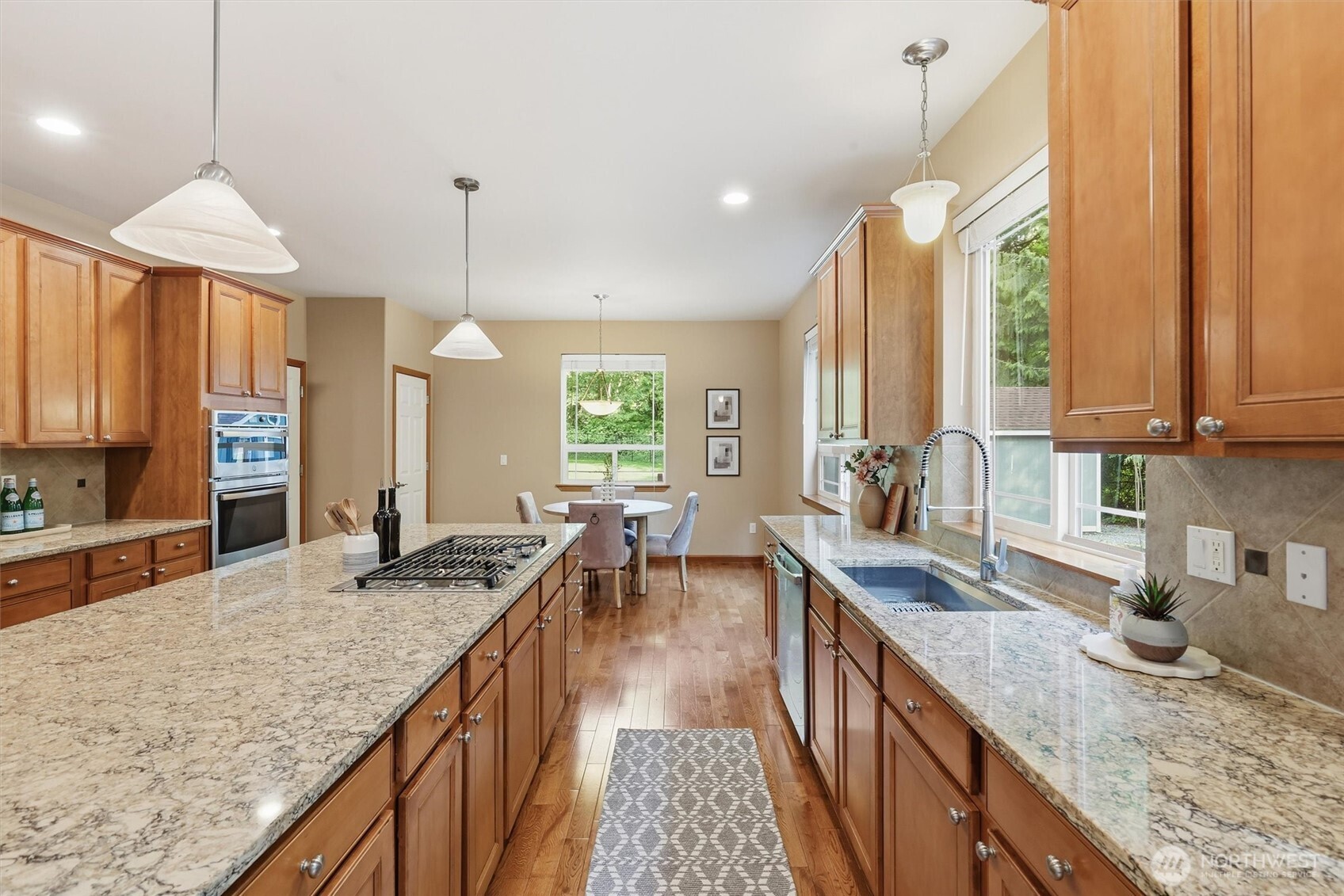 4202 Silvana Terrace Road Stanwood, WA 98292 - Photo 21 of 40 a kitchen with granite countertop a sink stove and cabinets