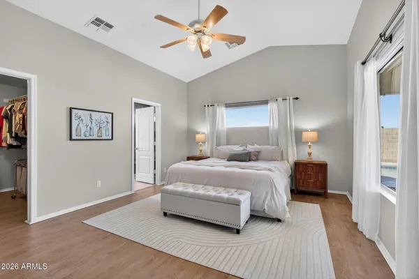 a bedroom with a bed and a chandelier fan
