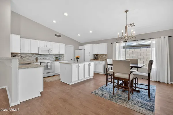 a large kitchen with a table and chairs