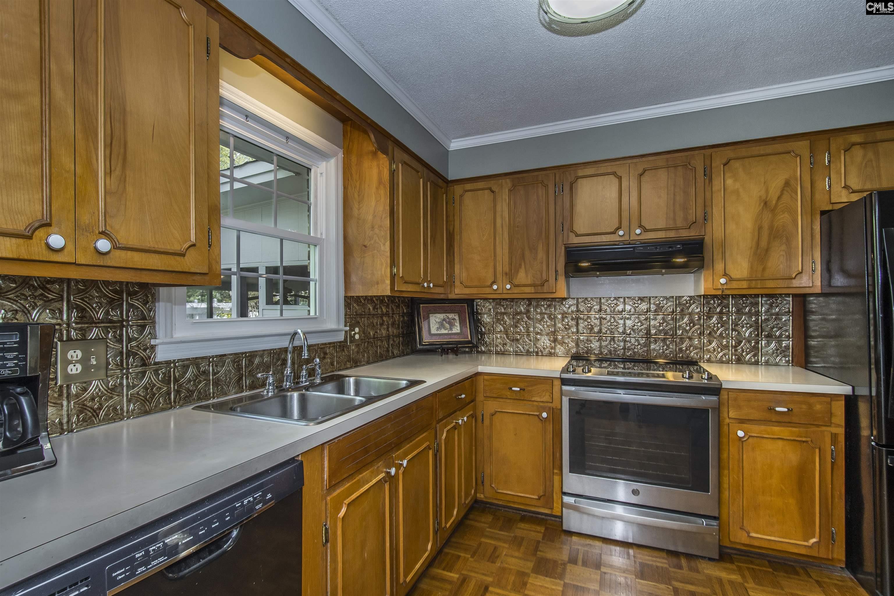 2309 Cunningham Road Columbia, SC 29210 - Photo 30 of 41 a kitchen with stainless steel appliances granite countertop wooden cabinets sink and a stove