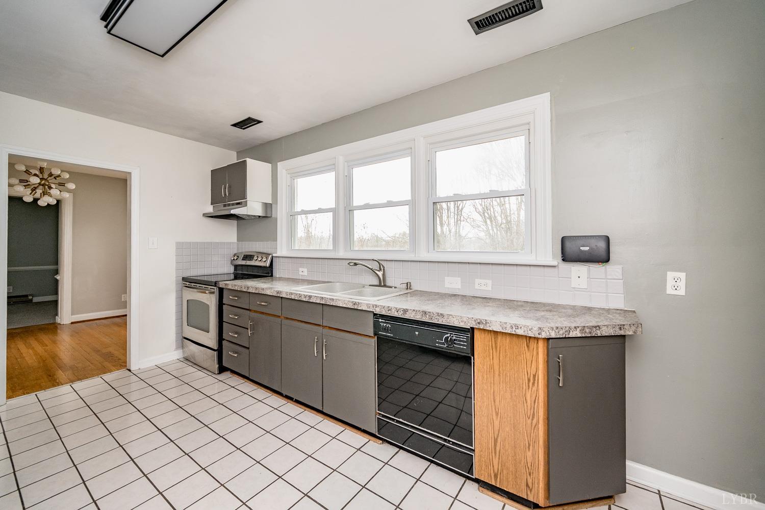 4925 Old Boonsboro Road Lynchburg, VA 24503 - Photo 14 of 57 a kitchen with stainless steel appliances granite countertop a sink and a stove
