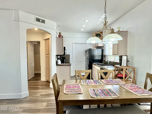a kitchen with a refrigerator sink and cabinets