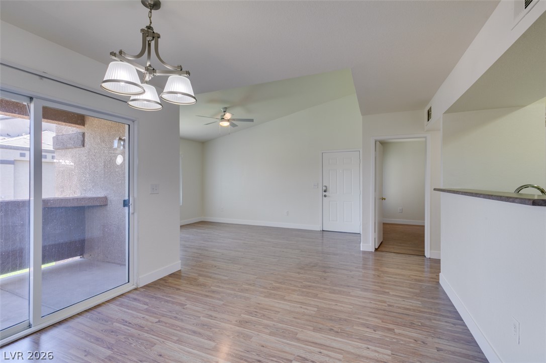 6650 West Warm Springs Road, Unit 2118 Las Vegas, NV 89118 - Photo 9 of 41 A well-lit interior space with wood flooring and vaulted ceilings, perfect for entertaining.