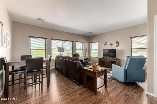a living room with furniture a flat screen tv and a large window