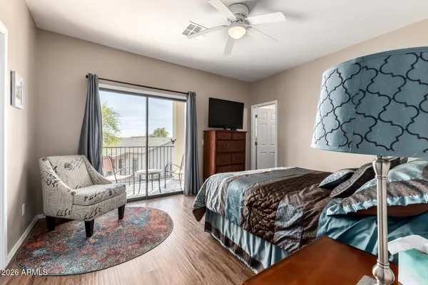 a bedroom with a bed a couch and dresser