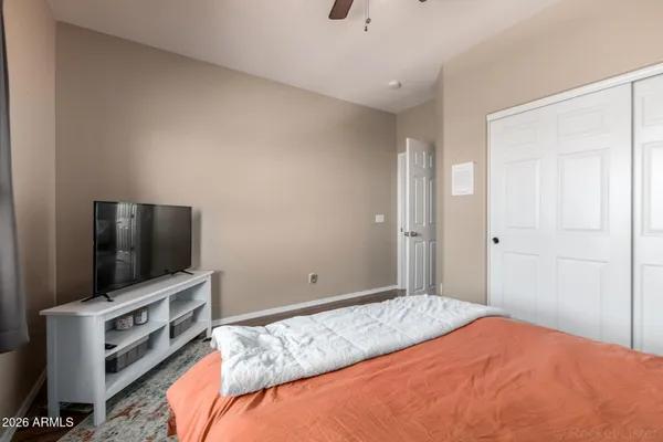 a bedroom with a flat screen tv and a bed